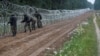 Poland -- Polish soldiers build a fence on the border between Poland and Belarus near the village of Nomiki, Poland August 26, 2021